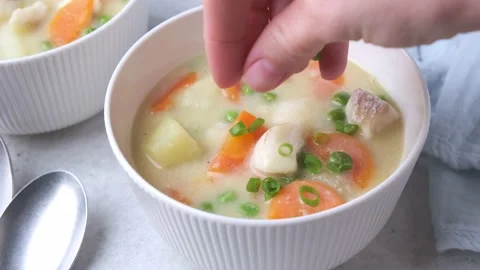 Fish cod chowder soup with green peas, potatoes and carrots. Stock Footage 220339358