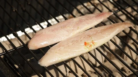Fish cooking on a BBQ Stock Footage 115057240