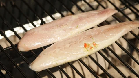 Fish cooking on a BBQ in slow motion Stock Footage 115057203