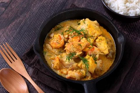 Fish curry with codfish, pollack and shrimps with coconut milk Stock-Fotos