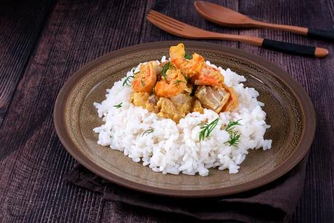 Fish curry with codfish, pollack and shrimps on rice Stock-Fotos