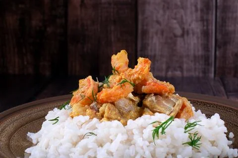 Fish curry with codfish, pollack and shrimps on rice Stock-Fotos