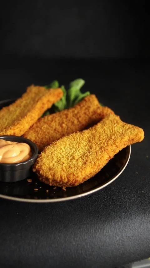 Fish cutlet breaded fish sticks shaped fish nuggets fast food fresh Stock Footage 311464978