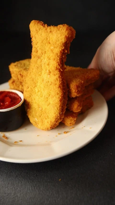 Fish cutlet breaded fish sticks shaped fish nuggets fast food fresh Stock Footage 311464987