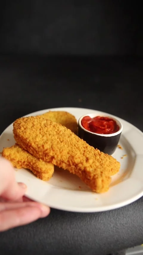 Fish cutlet breaded fish sticks shaped fish nuggets fast food fresh Stock Footage 311464994