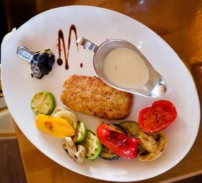 Fish cutlet from river walleye, served with grilled vegetables Stock Photos
