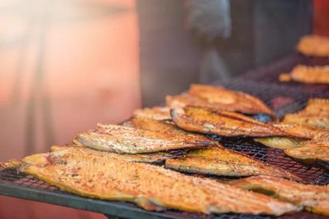 Fish of different varieties are grilled. Fishing season. Stock Photos