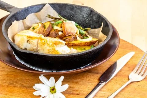 Fish dish - fried fish, fried potatoes and vegetables Stock Photos