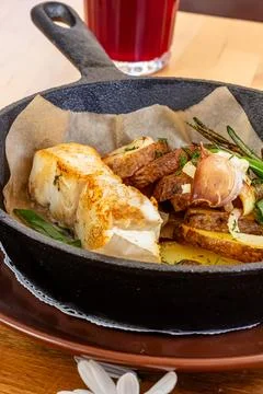 Fish dish - fried fish, fried potatoes and vegetables Stock Photos