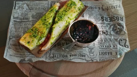 Fish dish with greens served over charcoal, wooden rotating tray, parchment Stock Footage 257763966