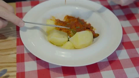 Fish dish for lunch break: a man's hands eat stewed hake or pollock with boiled Stock Footage 162401775