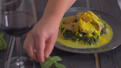 Fish dish with spinach decorated with basil Video stock 111966741