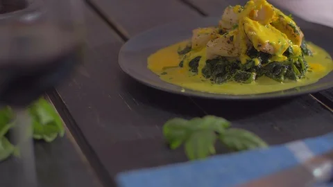 Fish dish with spinach decorated with basil Stock Footage 111966814