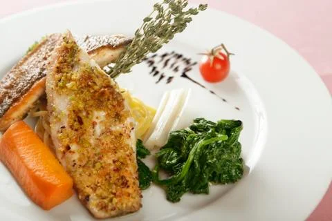 Fish dish with spinach Stock Photos