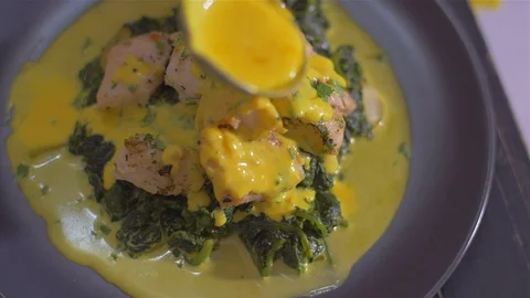 Fish dish with spinach. pouring sauce dish with turmeric Video stock 111967095