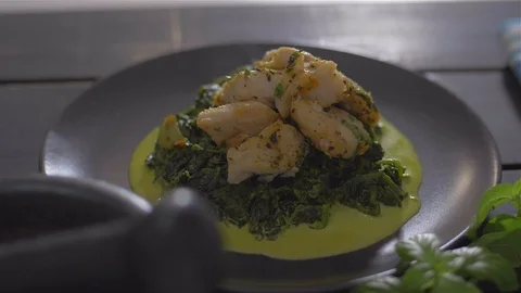 Fish dish with spinach. Sprinkle with parsley Stock Footage 111968289