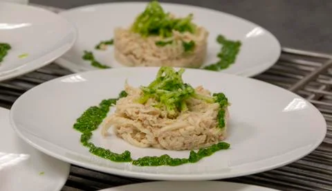 Fish dish with spinach on a white plate Stock Photos
