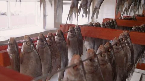 The fish is dried at a fish processing plant. Cooking dried processed Asian fish Stock Photos
