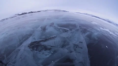 Fish-eye deep cracked ice on frozen Lake Baikal, Siberia largest freshwater lake Stock Footage 316453988