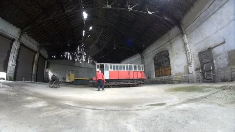 Fish eye shot of Man Dancing in an old train factory Stock Footage 104463476