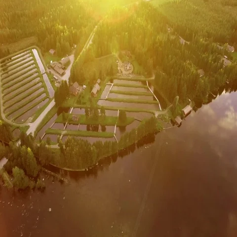 Fish farm pools by a streaming river with lens flare Stock Footage 69527062