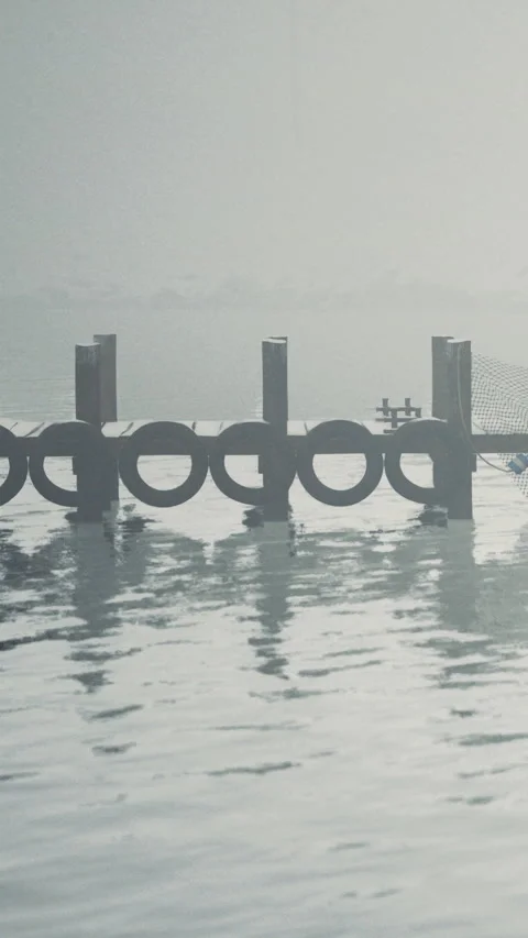 Fish farm structure stands in calm water during morning light hours Video stock 340639304