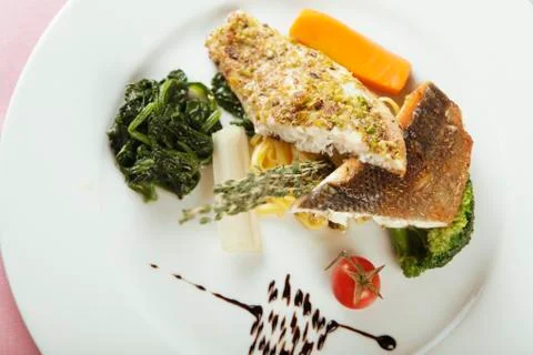 Fish fillet with spinach Stock Photos