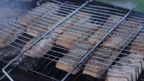 Fish fillets are cooked on a grill Stock Footage 159897706