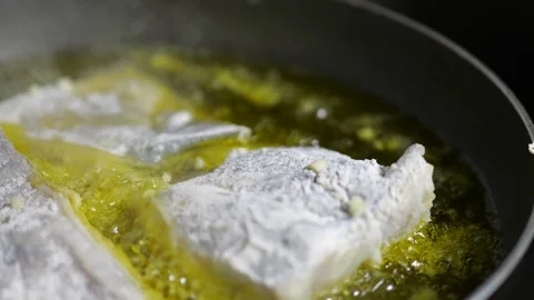 Fish Fillets Cooking in Bubbling Olive Oil Stock Footage 341679282