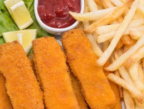 Fish fingers with chips (macro view) Stock Photos