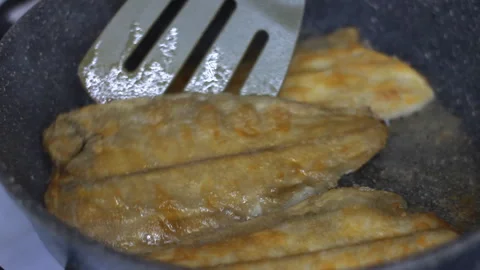 Fish fried in a frying pan close-up prepared in the traditional way with extra v Stock-Footage 259814115