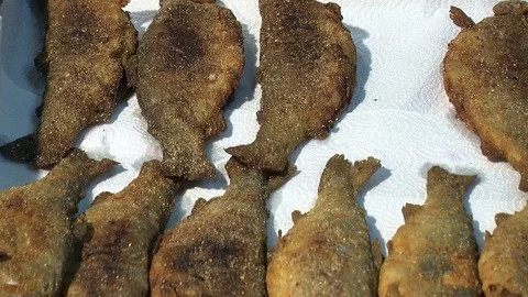 Fish fried in a frying pan until golden brown,Pieces of fresh fish are fried in  Stock Footage 90722450