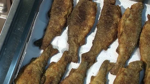 Fish fried in a frying pan until golden brown,Pieces of fresh fish are fried in  Stock Footage 90722629