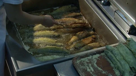 Fish fried in a frying pan until golden brown,Pieces of fresh fish are fried in  Stock Footage 90723011