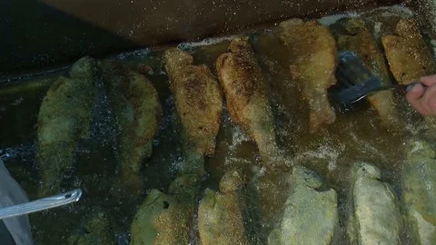 Fish fried in a frying pan until golden brown,Pieces of fresh fish are fried in  Stock Footage 90723133
