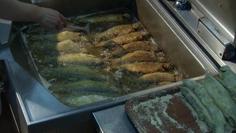 Fish fried in a frying pan until golden brown,Pieces of fresh fish are fried in  Stock Footage 90723142