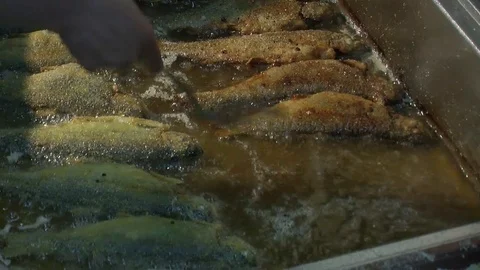 Fish fried in a frying pan until golden brown,Pieces of fresh fish are fried in  Stock Footage 90723205