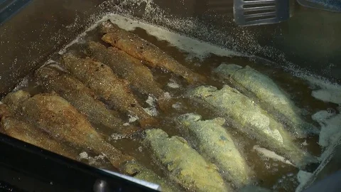 Fish fried in a frying pan until golden brown,Pieces of fresh fish are fried in  Stock Footage 90723930