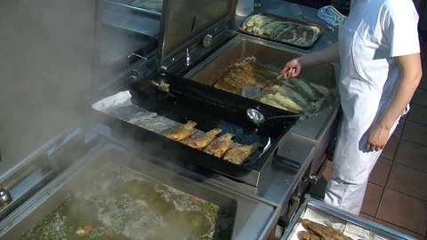 Fish fried in a frying pan until golden brown,Pieces of fresh fish are fried in  Stock Footage 90723954