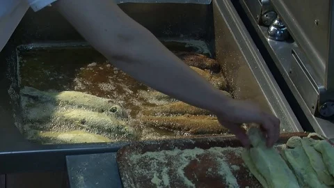 Fish fried in a frying pan until golden brown,Pieces of fresh fish are fried in  動画素材 90724644