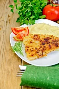Fish fried with mashed potatoes and tomatoes Stock Photos