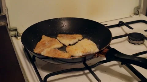 The fish is fried in a pan on the old gas stove Stock Footage 46401882