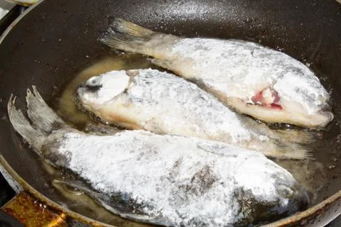 Fish fried on pan Stock Photos