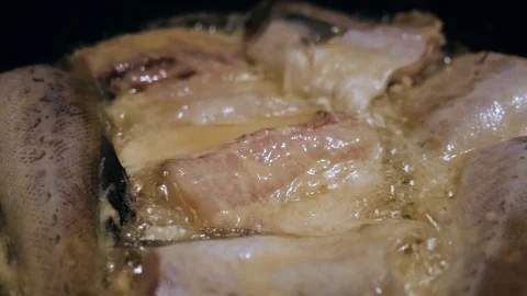 Fish, fried in a pan until golden brown Stock Footage 97762137
