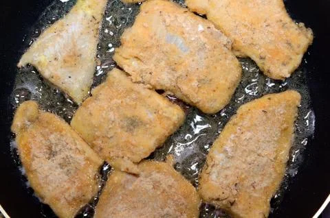 Fish on frying pan Stock Photos