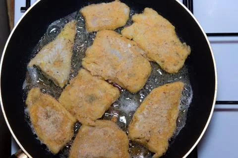 Fish on frying pan Stock Photos