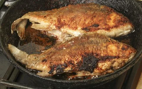 Fish in a frying pan Stock Photos