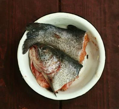 Fish head and tale close up photo in bowl ready for soup cooking Stock Photos