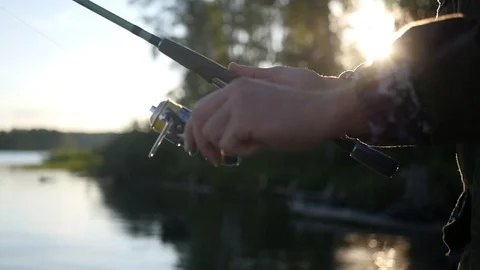 Fish on a hook, catching on spinning at sunset. HD, 1920x1080, slow motion Stock Footage 101503027