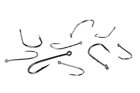 Fish hooks of different sizes on a white background Stock Photos